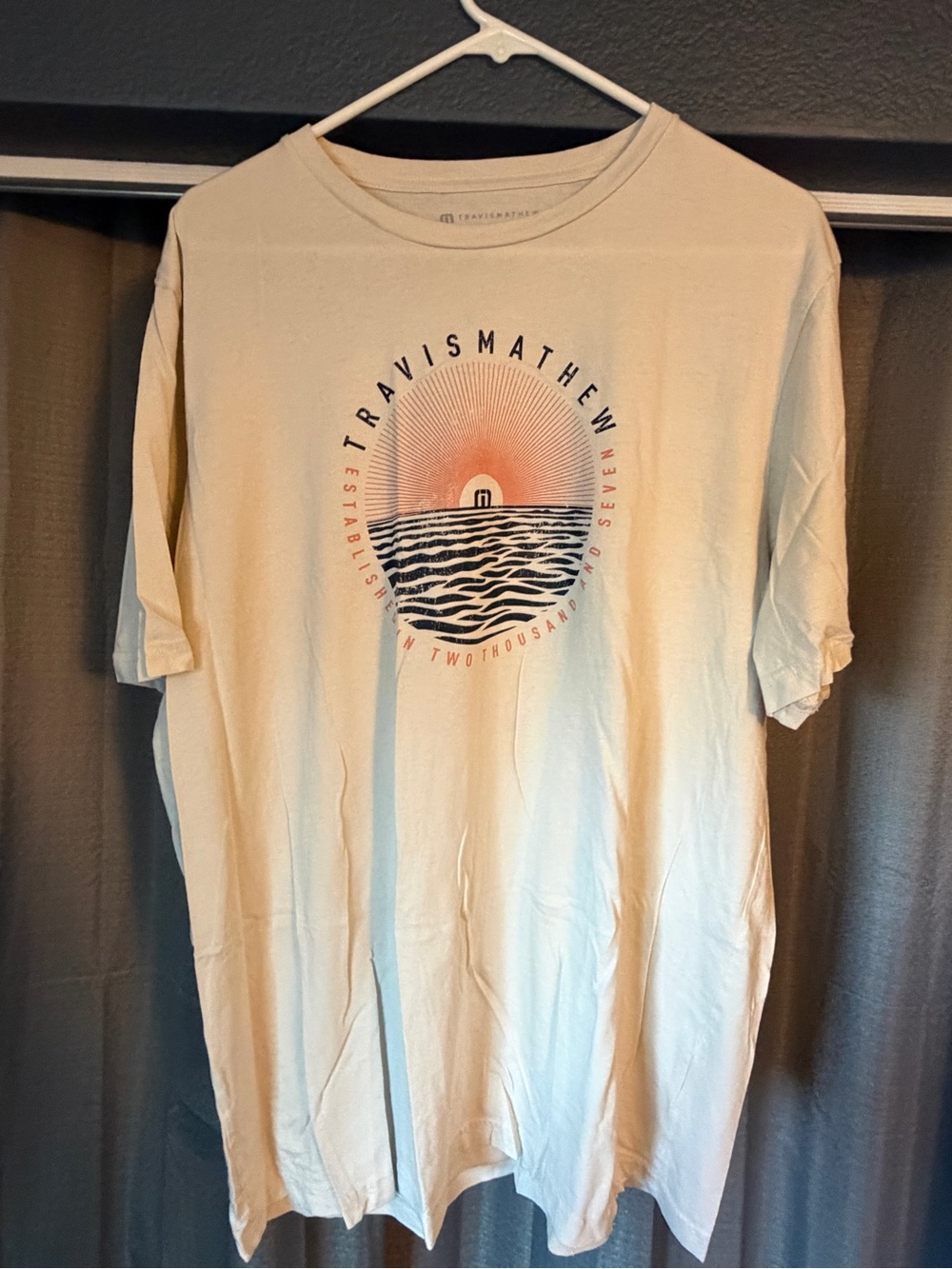 Travis Mathew Cream Short-Sleeve Tee with Sunset Wave Graphic